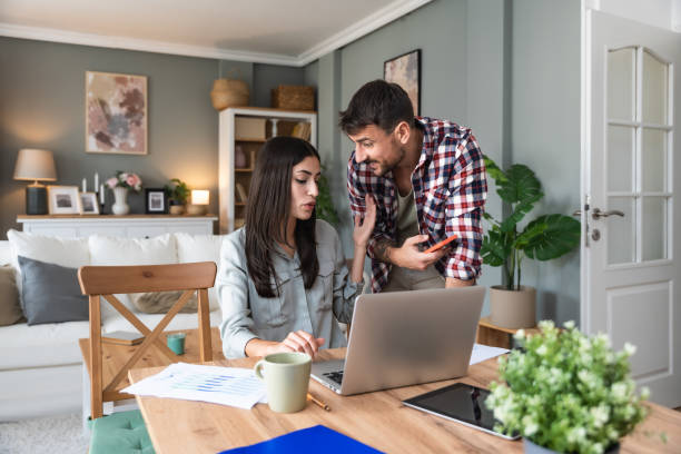 istock Young couple, freelancers small internet business owners, professional designers, computer software developers, working together at home, on new project. Businessman and businesswoman work together. 2154889864