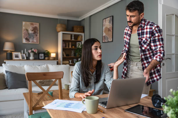 istock Young couple, freelancers small internet business owners, professional designers, computer software developers, working together at home, on new project. Businessman and businesswoman work together. 2154889876