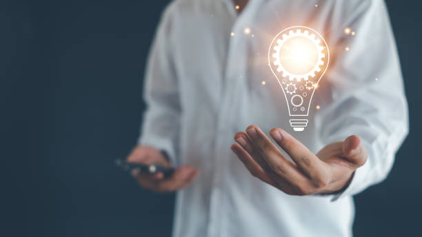 istock Idea innovation and inspiration concept.Hand of man holding illuminated light bulb, Idea innovation and inspiration concept.  creativity with bulbs that shine glitter, Concept for success. 2154893983
