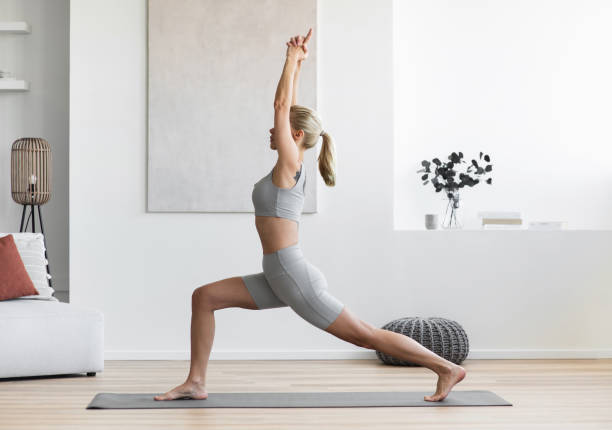 istock Woman practicing yoga, doing relaxation exercises, meditating at home 2154894702