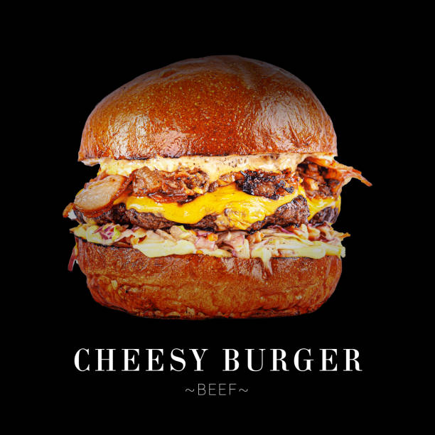 Cheesy beef burger with Cheddar cheese, minced bacon, onion confit, aioli and cheese sauce. Cheeseburger isolated on black background. Ready menu sandwich advertising banner with text and copy space