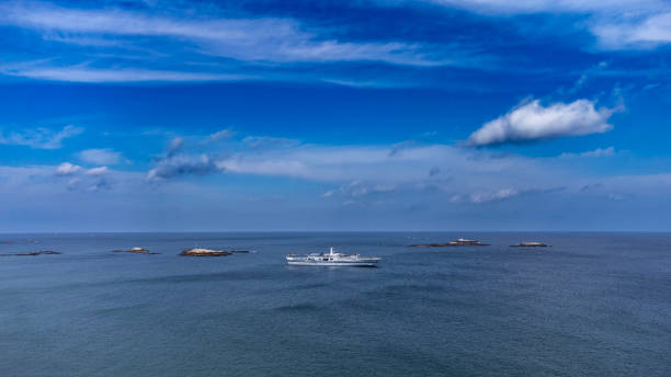 istock Ocean blue shiny water, clear sky and boat 2154895320