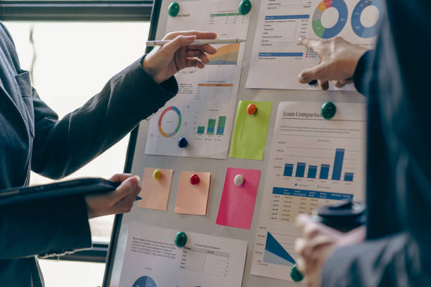 istock business meeting Executives engage in teamwork to analyze financial charts and graphs. Reflects professional technology planning and investment strategies, close-up images 2154895664