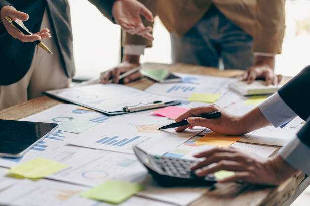 istock business meeting Executives engage in teamwork to analyze financial charts and graphs. Reflects professional technology planning and investment strategies, close-up images 2154895687