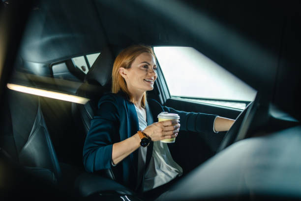 istock Female driver drinking coffee and driving a car 2154897319