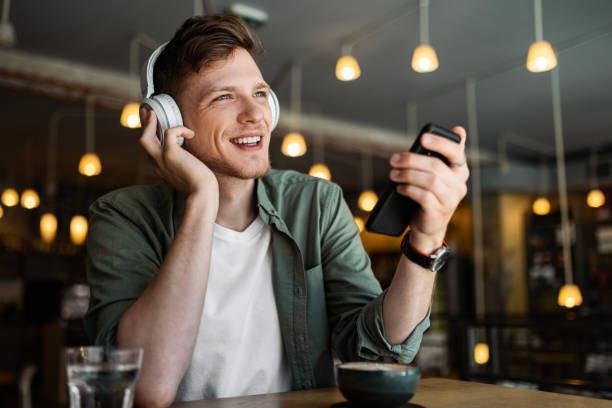 istock Man Listening to Music at Cafe 2154898536