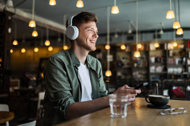 istock Man Enjoying Music at Coffee Shop 2154898543