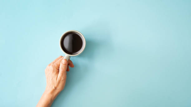 istock Hand holding a cup of coffee 2154898644