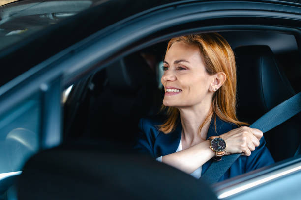 istock Female driver fastening her seatbelt 2154899420