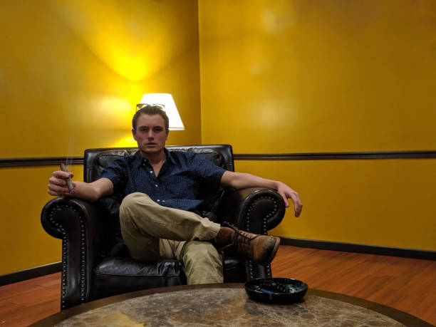 istock A man smoking a cigar on an armchair indoors 2154900275