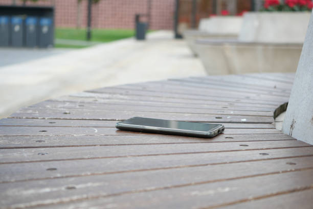 istock forget smartphone on a park bench, lost smart phone 2154900389