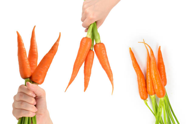 istock Fresh orange carrot in woman hands on a white background. 2154902148