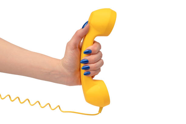 istock Yellow handset in woman hand isolated on white. Copy space. 2154902194
