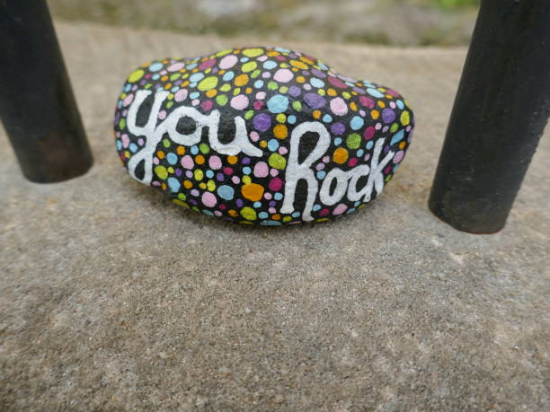 istock You rock kindness rock between two metal bars 2154904470