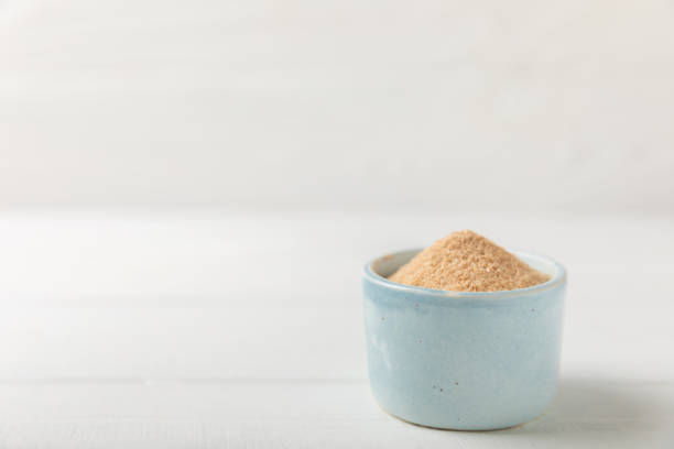 istock Cinnamon sugar on a texture background. Homemade cinnamon sugar in a bowl on background. Brown sugar. Spice mixture for drinks and baking. Place for text. Copy space. 2154906453
