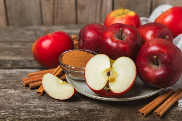 istock Apples with cinnamon on background. Fragrant red spiced apples with cinnamon sticks and star anise. Apple slices with spicy spices. Place for text. Copy space. Harvesting. Fruits. 2154906515