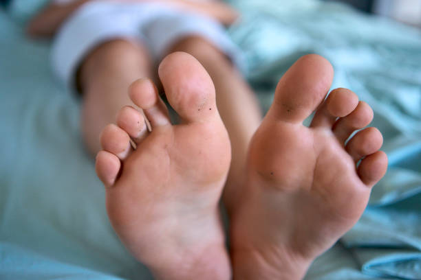 istock man is lying on a bed, big feet on the bed 2154906972