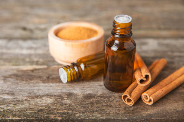 istock Cinnamon aromatic essential oil and cinnamon sticks on a wooden background. Aromatherapy. Organic cosmetic oil. Spa concept. Place for text. Copy space. 2154907463