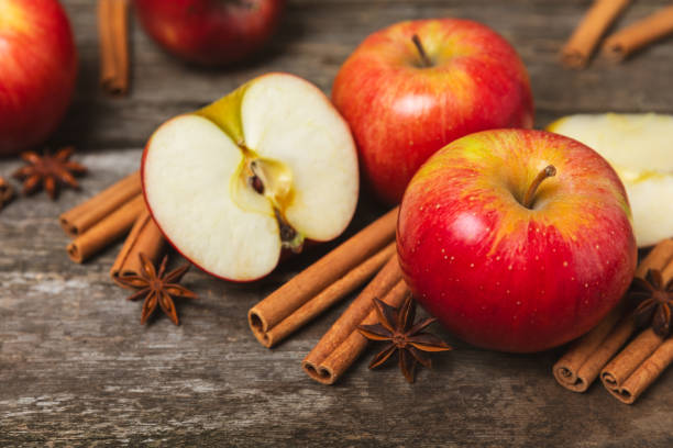 istock Apples with cinnamon on a textured wooden background. Fragrant red spiced apples with cinnamon sticks and star anise. Apple slices with spicy spices. Place for text. Copy space. Harvesting. Fruits. 2154907621