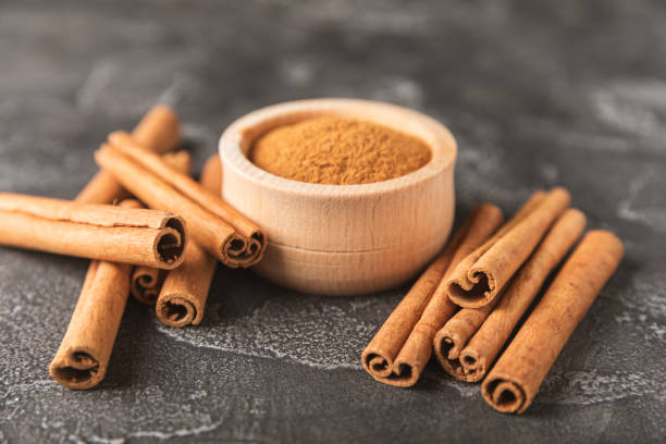 istock Cinnamon sticks on a textured wooden background. Cinnamon roll. Spicy spice for baking, desserts and drinks. Fragrant ground cinnamon. cinnamon powder Close-up. Place for text. copy space 2154907883