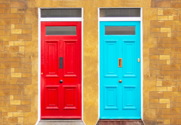 istock two blue and red doors in yellow brick wall, street facade 2154910894