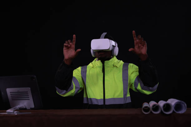 A Male Industrial Engineer Wearing a Virtual Reality Headset and Holding Controllers, He Uses VR technology for Industrial Design, Development, and Prototyping in CAD Software.
