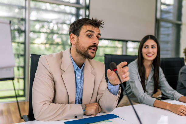 istock Man CEO talking on the microphone on meeting with his colleagues about business plan, future collaboration. 2154911519