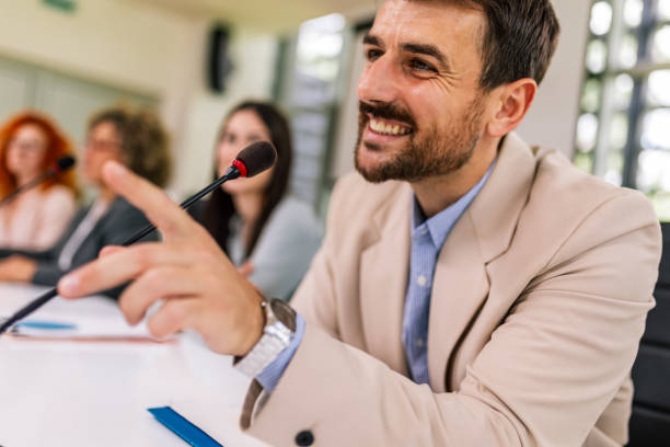 istock Man CEO talking on the microphone on meeting with his colleagues about business plan, future collaboration. 2154911563