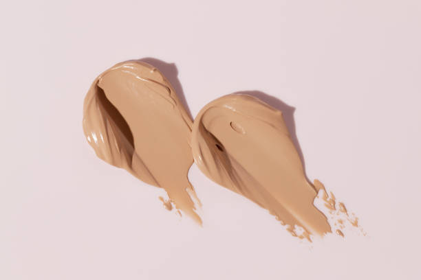 istock Makeup foundation, beige concealer swatch smudge smear on pink background. BB CC cream texture 2154914477