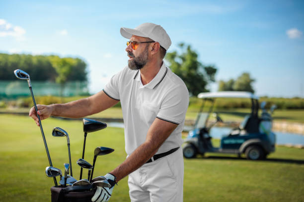 istock Handsome golfer picking his golf clubs 2154914530