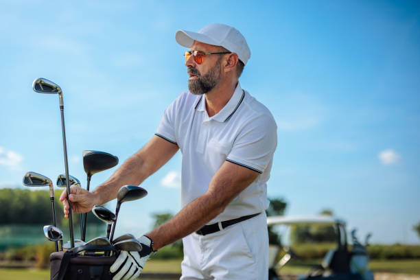 istock A mature golfer selects his golf clubs 2154914539