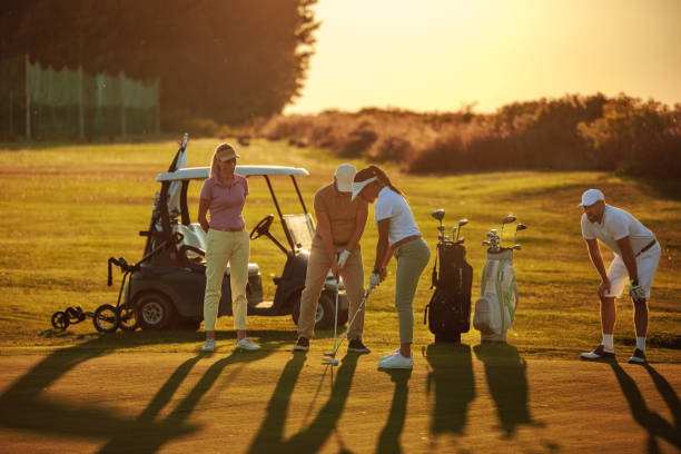 istock People playing golf in the sunset 2154914580