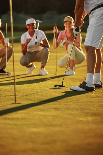 istock A golfer hitting a ball while his friends watch 2154914582