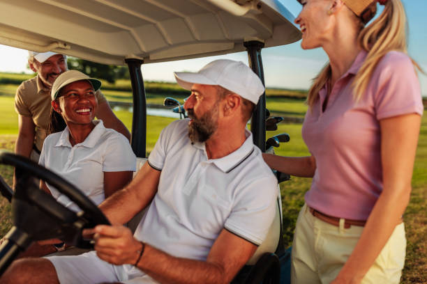 istock Four friends talking by the golf cart 2154914588