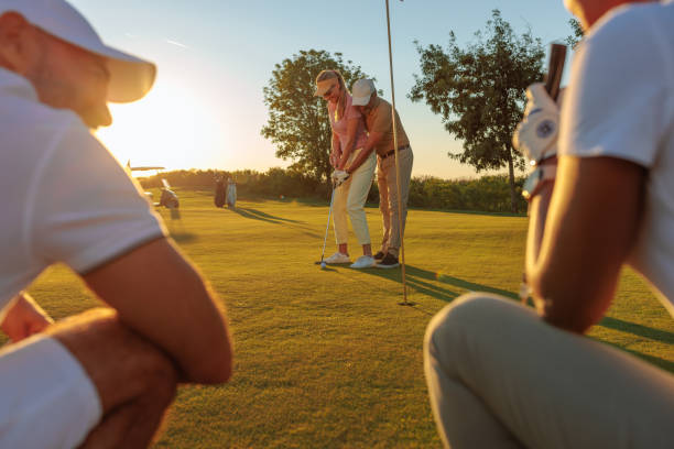 istock Golfer instructs a female golfer on how to play 2154914596
