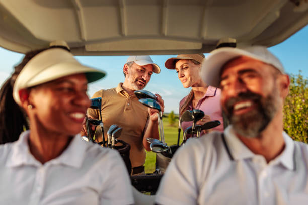 istock Two couples out golfing in a golf cart 2154914604