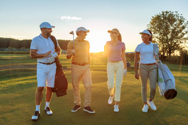 istock Four friends walking on a golf court 2154914608
