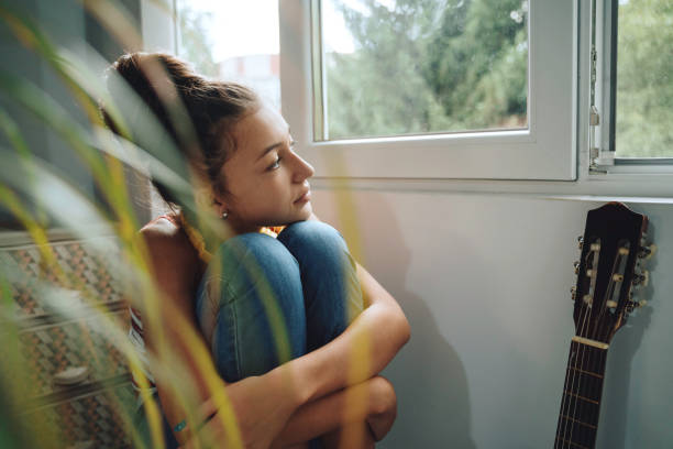 istock Pensive young lady by the guitar 2154916135