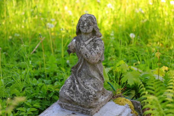 istock A stone figurine covered with tarnish and a green background 2154917810