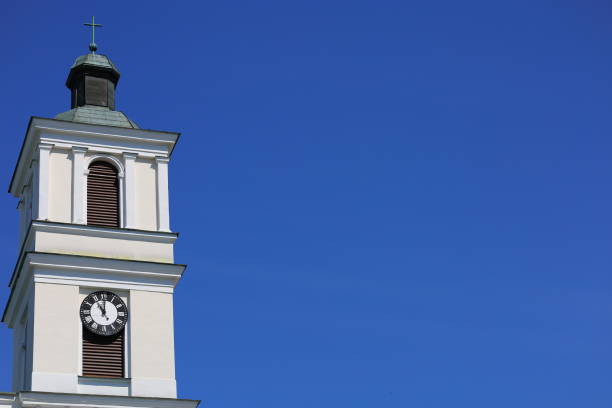 istock The clock on white tower and the blue sky 2154917898