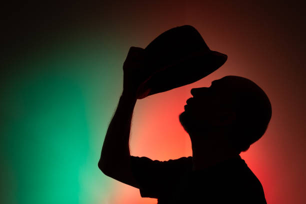 istock Studio portrait of a man holding hat in silhouette. 2154918026