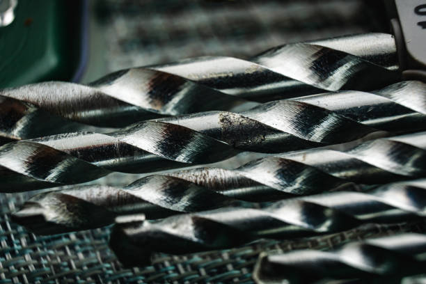 This close-up view showcases a variety of metal drills, including drills and screw bits, creating an intricate display of technical mechanical elements.