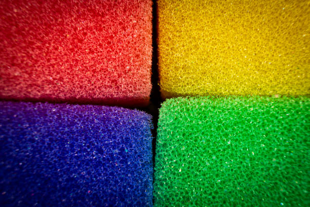 This close-up shot showcases a colorful sponge with a rainbow gradient background. The vivid hues create a striking visual impact, revealing the intricate details of the sponges texture and vibrant color palette.