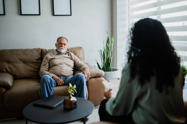 istock Senior man talking with pshychotherapist during therapy session at clinic 2154925937