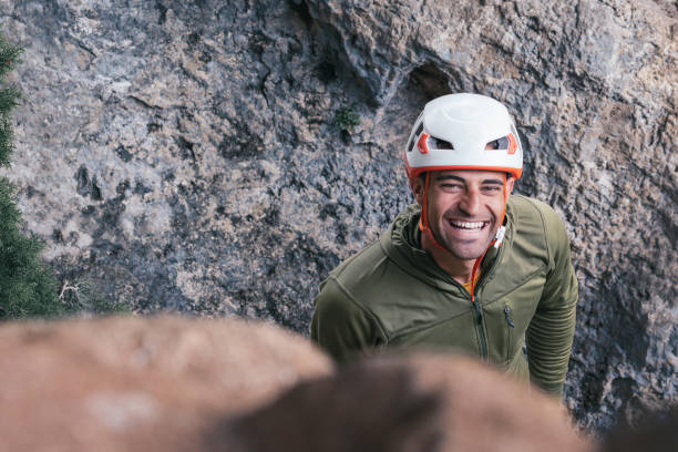 istock A man wearing a helmet and a green jacket is smiling at the camera 2154927700