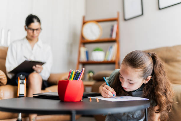 istock Child girl drawing using colored pencil at psychotherapy (or at home) 2154930732