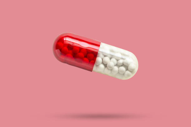 istock medicine capsule isolated on pink background 2154933527