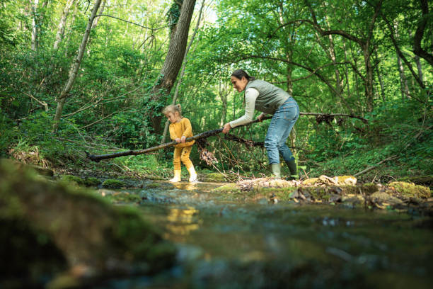 istock Green Mindset. Family Cleaning Riverbed in Forest. 2154933701