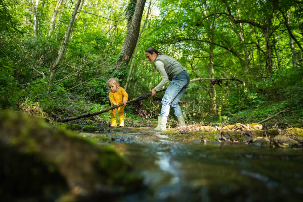 istock Environmental Sustainability. Family Cleans Riverbed. 2154933714