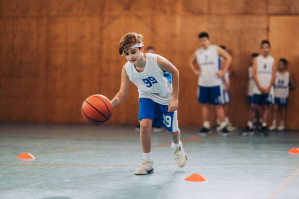 istock Junior basketball player in action dribbling a ball and practicing. 2154933831